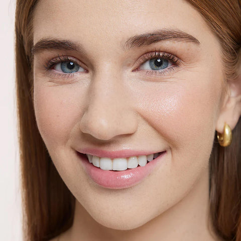 Close-up of a woman's face wearing Flawless Concealer in Porcelain Beige shade.