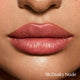 Close-up of lips with '06 Dusky Nude' lipstick color swatch.