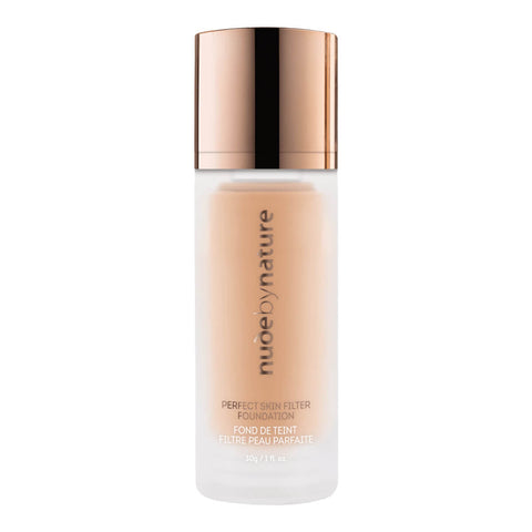 Nude by Nature foundation bottle with a rose gold cap on a white background.