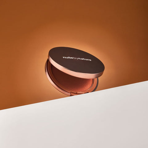 Compact Nude By Nature Pressed Matte Mineral Bronzer 10g case on a gradient background.