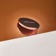 Compact Nude By Nature Pressed Matte Mineral Bronzer 10g case on a gradient background.