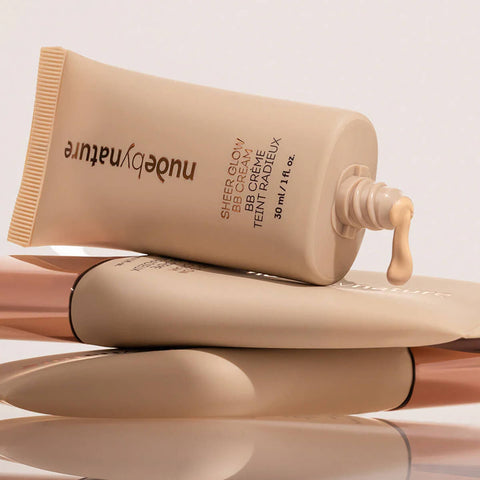 Tube of Nude by Nature BB cream on a reflective surface with a light background.