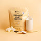 Nutra Organics Organic Whey Protein - Vanilla 750g package with vanilla flowers and a scoop on a yellow background.