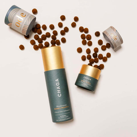 Ode Health Chaga Mushroom honey pearls 21 pearl pack and 90 pearl pack. Pearls spilling out on a white background. 