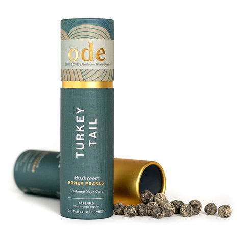 Turkey Tail mushroom honey pearls packaging with open lid on a white background.