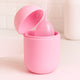Pink silicone cup with a lid on a light pink background