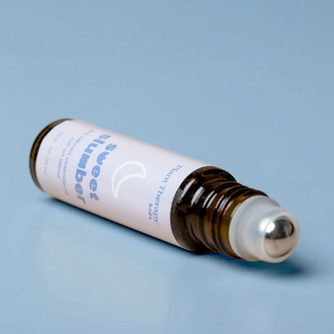 Plant Therapy Essential Roll-on Blend - Sweet Slumber 10ml product on a blue background.