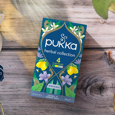 Pukka herbal collection packaging on a wooden surface