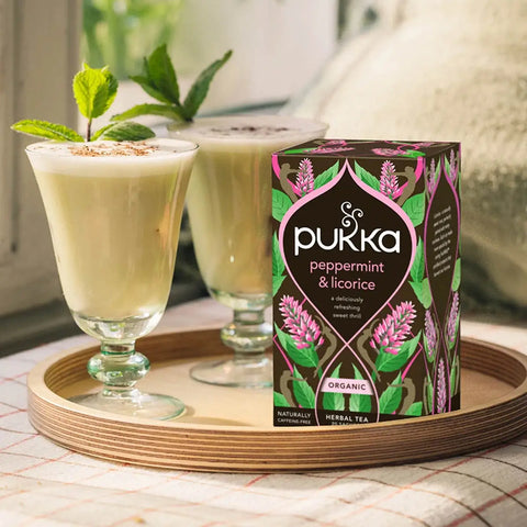 Pukka peppermint & licorice tea packaging with a drink on a tray