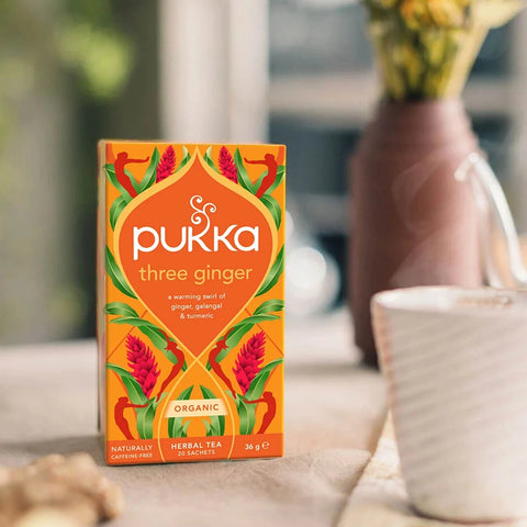 Pukka three ginger tea box on a table with a blurred background