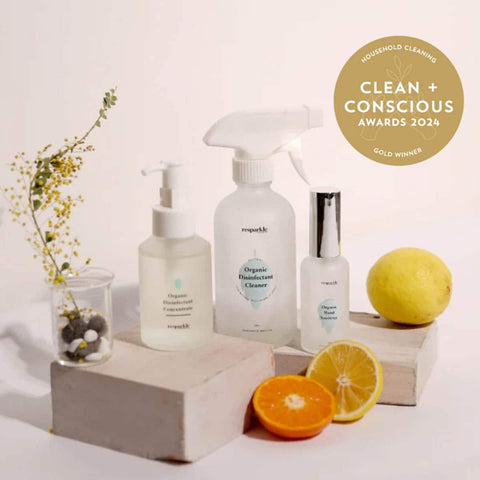 Three bottles of resparkle cleaning products with a lemon and orange on a white background, featuring the 'Clean + Conscious Awards 2024' gold winner badge.