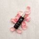 Retreatment Botanics Collagen Calm Activated Mist 100ml bottle with pink petals on a textured surface.