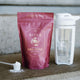 Purple package of Ritua Creatine Monohydrate with a scoop and container on a textured surface.