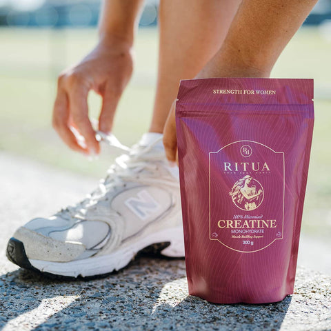 Hands tying shoelace next to a package of Ritua Creatine - Strength For Her 300g.