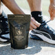 Hand tying shoelace next to black packaging of Ritua Creatine - Strength For Him 300g. 