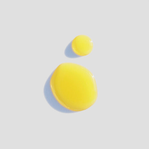 Sodashi Rejuvenating Serum yellow liquid drops on a light grey background. 