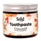 Jar of Solid Toothpaste Cinnamon with Fluoride on a white background