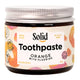Jar of Solid Toothpaste Orange with Fluoride on a white background