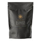 A black resealable stand-up pouch of Superfeast Women's Rhythm food powder, featuring gold and white text on a clean white background.