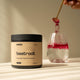 Container of 'switch' beetroot powder with a glass of pink liquid on a neutral background.