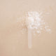 White powder on a beige background.