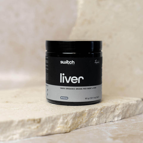 Black container labeled 'switch liver' on a stone surface.