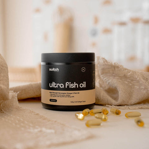 Container of ultra fish oil with capsules on a neutral background.