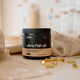Container of ultra fish oil with capsules on a neutral background.