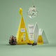 Cosmetic products and packaging from The Jojoba Company on a green background.