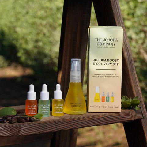 The Jojoba Company product set on a wooden surface with a natural background
