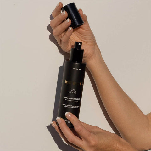Open spray bottle of Three Warriors Body Tan Aqua Mist