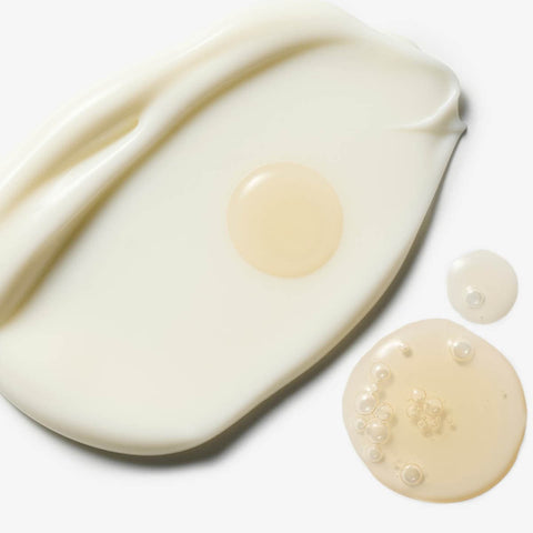 Close up of moisturiser swatch with tan drops.