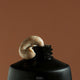 Sand scrub being squeezed out of tube set against a brown background.