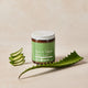Jar with aloe vera leaves on a beige background.