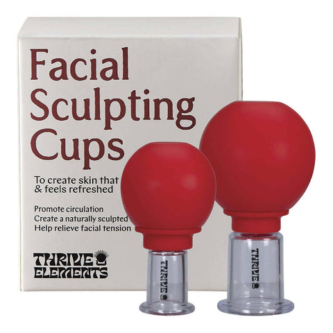 Red facial sculpting cups with clear bases in front of a white box labeled 'Facial Sculpting Cups'.