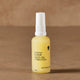 Yellow bottle of 'Hydrating Elixir Face Oil' by Thrive Tallow on a brown background.