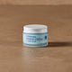 Jar of Revive Creme by Thrive Tallow on a brown surface.