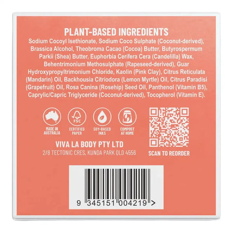 Back of a solid shampoo product box with a coral-pink background, white text listing plant-based ingredients, icons for made in Australia, FSC, soy-based, and compostable, and a barcode.