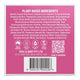 The back of a solid shampoo box, showing a list of ingredients, certification icons, QR code, and a barcode on a pink background.