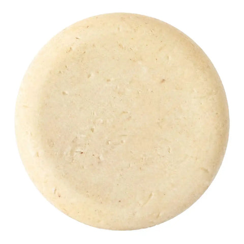 A round, off-white soap bar, shown from a top-down view on a solid white background.