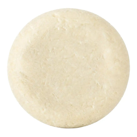 A round, textured bar of soap in an off-white colour, shown from a top-down view on a solid white background.