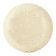 A round, textured bar of soap in an off-white colour, shown from a top-down view on a solid white background.