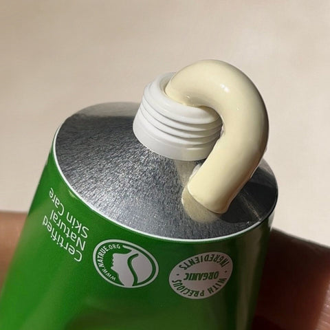 White cream coming out of a Skin Food aluminium tube.