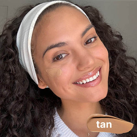 Woman with a tan bb cream swatch on her face.