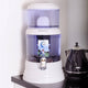 zazen Water Alkaline Water System - Plastic Bottom Tank on a kitchen counter with a kettle in the background.