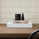 2 items from the parasite & heavy metal detox set, styled on a table with white tiled background and stacked on 2 white books with a beige tray. 