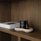 Para protocol & fulvic humic drops on a beige tray on a dark wooden shelving unit.